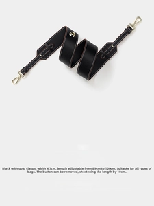 Adjustable black leather shoulder strap with gold clasps and white stitching detail