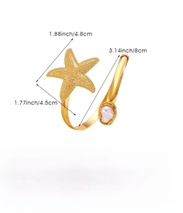 Close-up of golden starfish arm cuff with pearl detail and adjustable size specifications