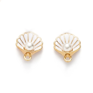 Detailed view of gold shell pendants with white enamel and centered pearls