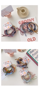 Detailed view of colorful elastic hair bands with bows on elegant packaging cards