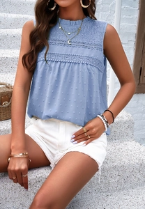 Detail of blue sleeveless top featuring dot texture, lace lace-up collar and pleated chest