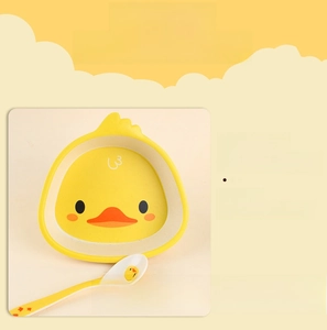 Detail of yellow duck toddler bowl with matching spoon showing smooth edges and cute design