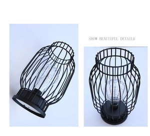 Detailed macro view of black iron lantern frame with vintage LED bulb and internal wire lights