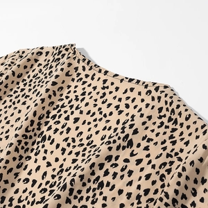 Detail of V-neckline and shoulder tailoring on vintage leopard print satin dress