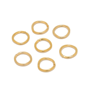 Macro detail of seven 18K gold-plated stainless steel open jump rings for DIY jewelry