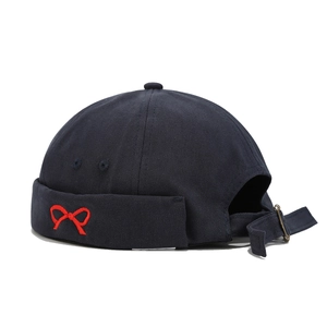 Navy blue canvas docker hat with red bow embroidery and adjustable back strap