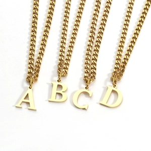 Detail view of 18K gold plated necklaces featuring A B C D letter pendants on fine chains