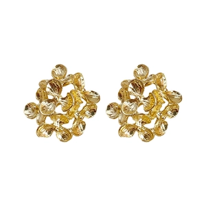 Elegant gold flower stud earrings with hammered metal texture on white background