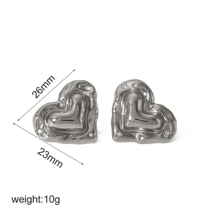 Detail of silver heart earrings with lava texture, rhinestones and 26mm size marking