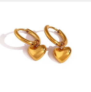 Detailed view of polished golden heart drop earrings featuring stylish round hoop clasps
