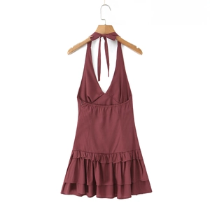 Macro shot of tiered ruffles and halter tie neck on a burgundy summer mini dress