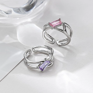 Detailed shot of silver adjustable rings with rectangular pink and purple gemstones