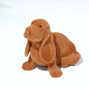 Macro detail of brown flocked puppy jewelry box showing soft velvet texture and design