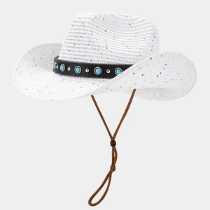 Detail of white straw cowboy hat featuring turquoise stones and silver studs on leather band