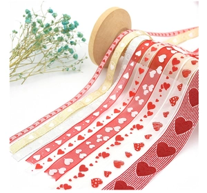 Close-up of assorted heart-patterned ribbons on wooden spools for gift wrapping