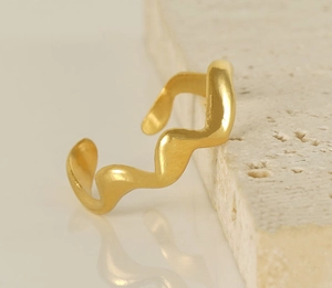Macro shot of 18K gold wave pattern adjustable open ring with matte finish texture