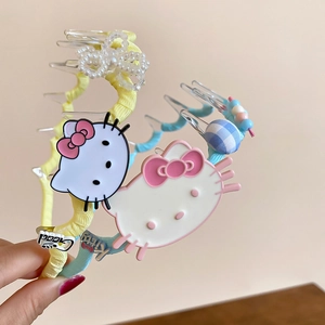 Detail of Hello Kitty spiral headbands with pearl accents and blue striped charms