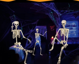 Three realistic plastic skeletons in a haunted bar setting with purple spider webs