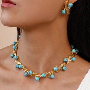 Golden turquoise jewelry set featuring geometric twisted necklace and stud earrings