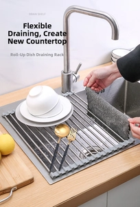 Detail showing the roll-up stainless steel kitchen sink drying rack with silicone edges