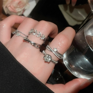 Close-up of silver ring set with zircon leaves and stars on fingers for women