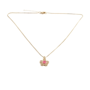 Detail of gold flower pendant necklace with pink smiley face and zircon crystals