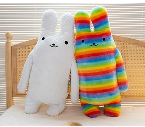 Detail of plush rabbit pillows in white minky fabric and colorful rainbow stripes