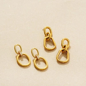 Detailed view of 18K gold plated double oval earrings with pavé zircon setting