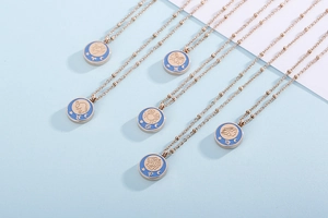 Detailed macro view of rose gold coin necklaces with engraved zodiac constellation pendants