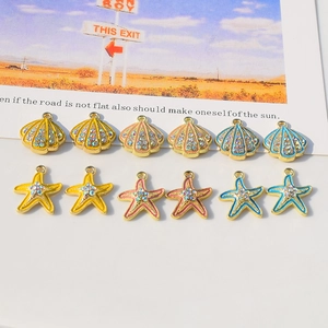 Detailed view of colorful seashell and starfish charms with rhinestones for DIY jewelry