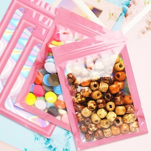 Pink holographic resealable jewelry pouches with clear window showing beads inside
