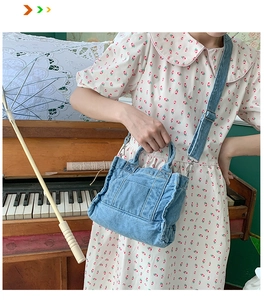 Close-up of retro blue denim tote bag with adjustable strap and front pocket detail