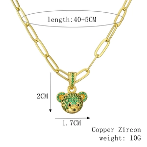 Detail view of gold bear pendant with green zircon inlay including size measurements