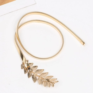 Detailed view of golden leaf buckle and metallic spring texture of the elastic waist chain