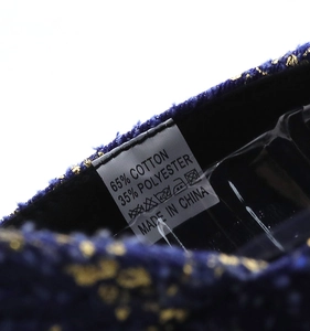 Detail view of cotton-polyester washing label on blue denim floral baseball cap