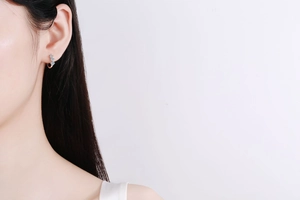 Detail showing high-end 925 sterling silver hoop earring with stones worn by a model