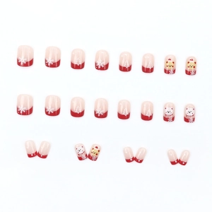 Christmas press-on nail kit featuring red snowflakes, trees, and cute cartoon bears