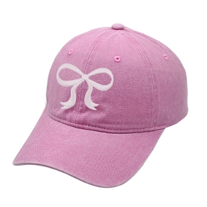 Vintage pink washed cotton baseball cap with white bow embroidery at a 45-degree angle
