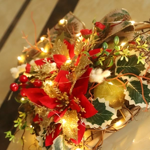 Christmas heart wreath with red poinsettia, pine cones, berries and warm LED lights