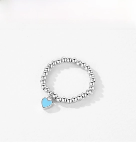 Detail view of s925 silver beaded ring with a light blue heart enamel charm