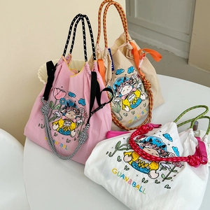 Detail view of waterproof nylon shoulder bags with cartoon embroidery and rope handles