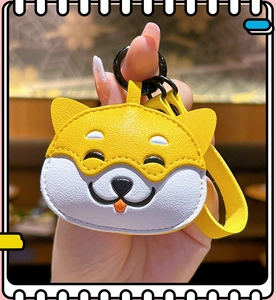 Close-up of cute yellow leather Shiba Inu coin purse with wrist strap and metal ring