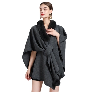 Women's dark grey knit poncho cardigan with black faux fur collar and bow tie closure