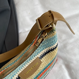 Chic color-block woven shoulder bag with brown leather strap and gold-tone zipper details