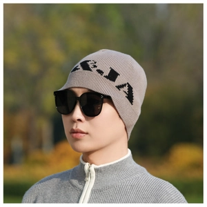 Outdoor shot of a gray ribbed knit beanie with black letter design and sunglasses