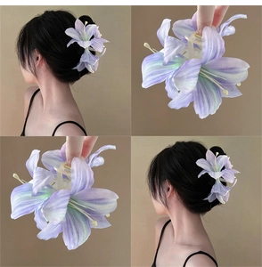 Detailed views of a large purple lily hair claw clip with realistic silk texture