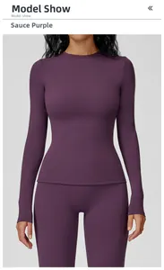 Front view of slim fit dark purple long sleeve yoga top and leggings on a model