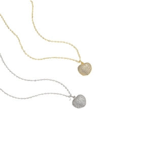 Elegant gold and silver heart pendants with sparkling crystals on minimalist chains