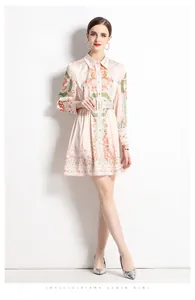 Close-up of pink satin dress with nautical shell prints and decorative waist belt