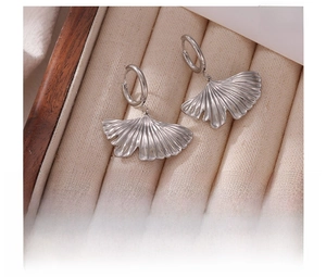 Macro detail of silver ginkgo leaf earrings in titanium steel with radial textures